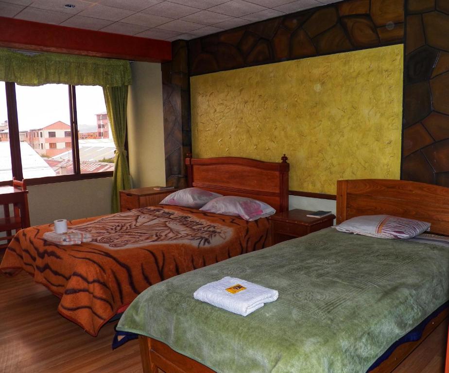 Кровать или кровати в номере Hotel folklore's