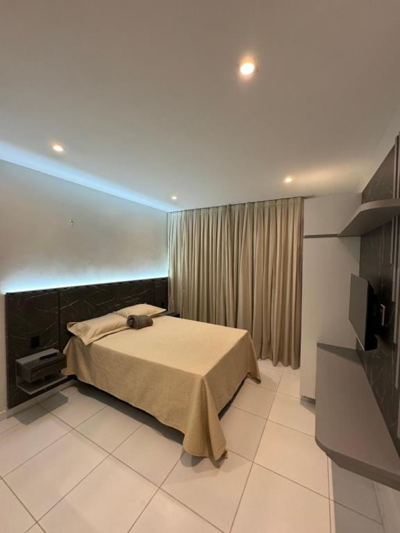 a bedroom with a bed and a blue light at Apartamento localizado em condomínio fechad0 em Barra Grande - PI in Parnaíba