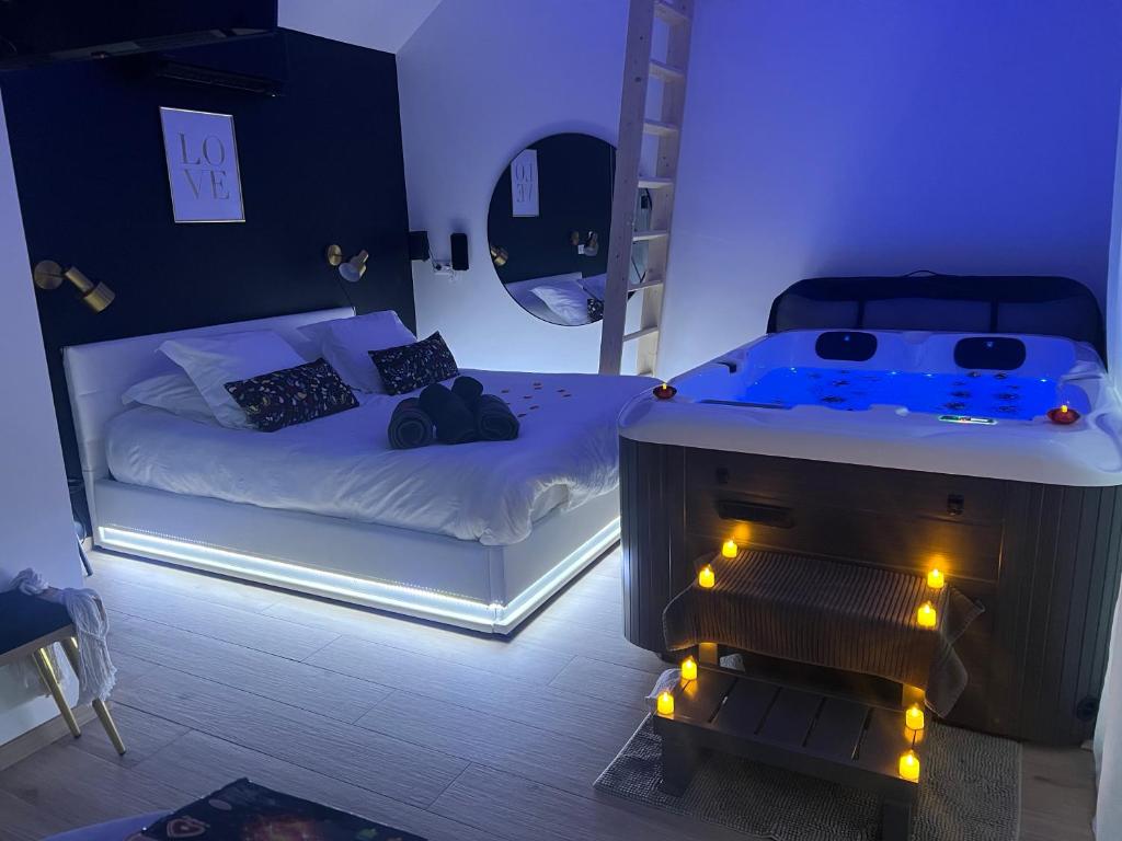 Ένα ή περισσότερα κρεβάτια σε δωμάτιο στο Suite romantique avec Spa et filet suspendu