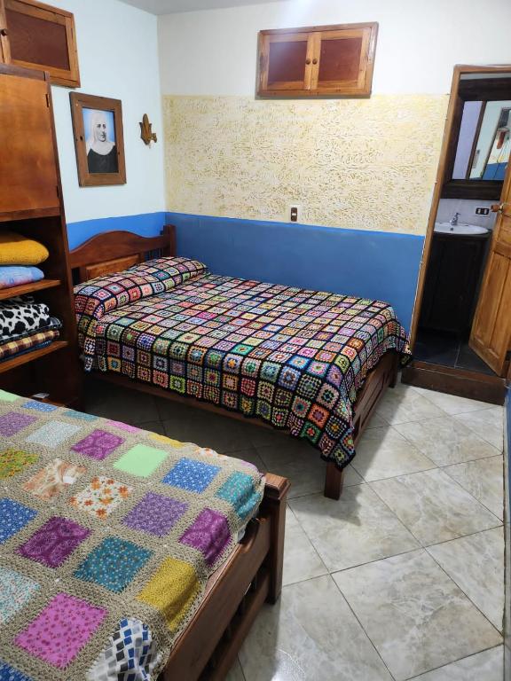 Postel nebo postele na pokoji v ubytování Hotel Atenas Jericó