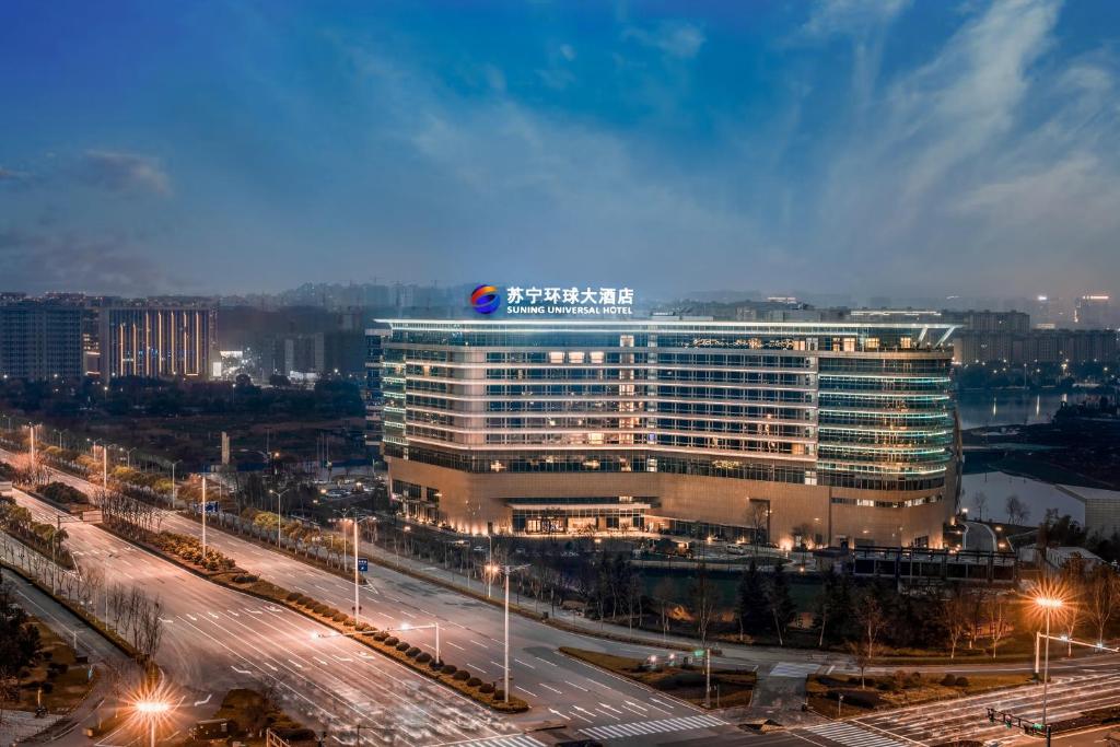 a large building with a sign on top of it at Wuhu Suning Universal Hotel in Wuhu