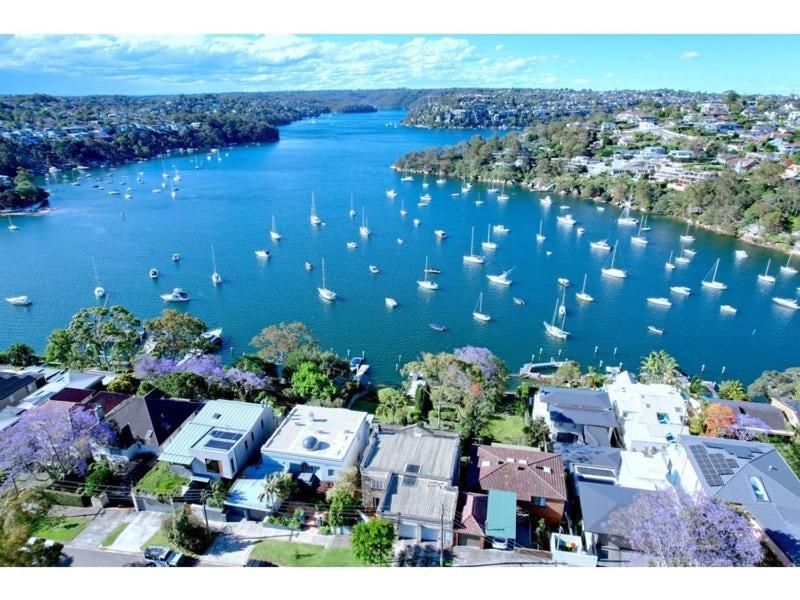 an aerial view of a harbor with boats in the water at Picture-Perfect Masterpiece In Exclusive Mosman in Sydney