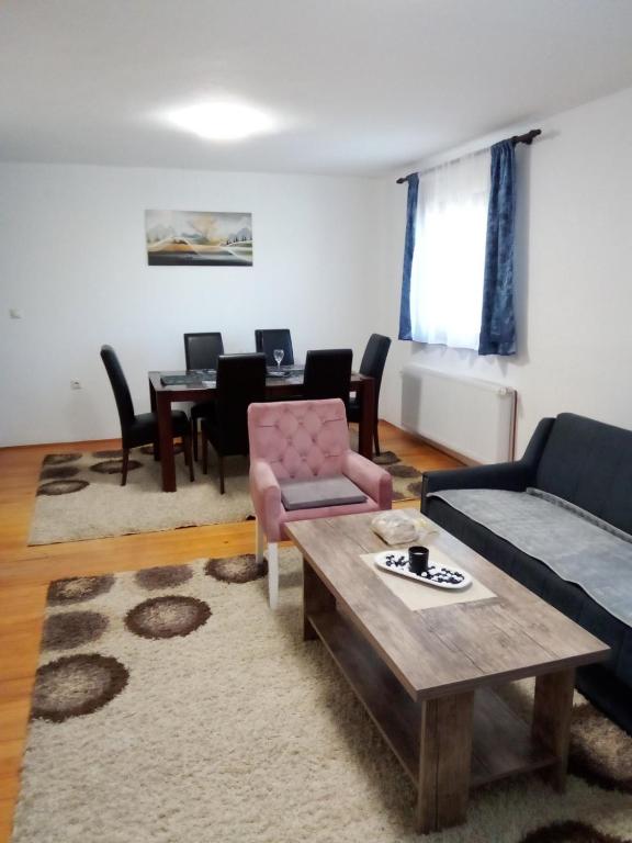 a living room with a couch and a table at Apartman Goga in Pale