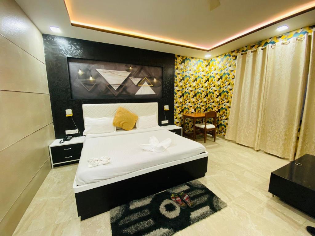 a hotel room with a bed and a chair at Shree R.C.VATIKA in Motīhāri