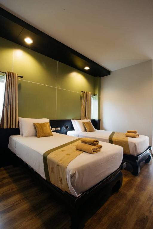Postel nebo postele na pokoji v ubytování Diamond Park Inn Chiangrai & Resort