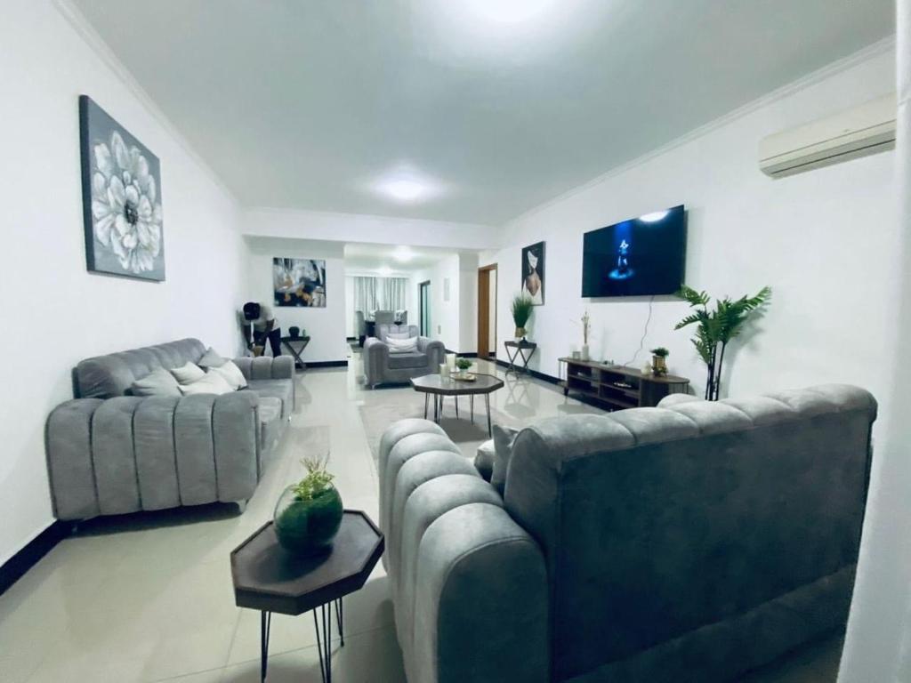 a living room with two couches and a table at Appartement Meublé haut standing in Brazzaville