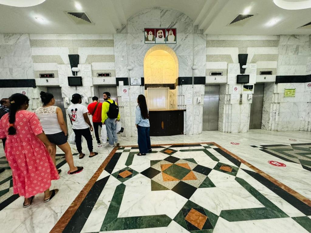 a group of people standing in a room with a tiled floor at small room PM new location in Abu Dhabi