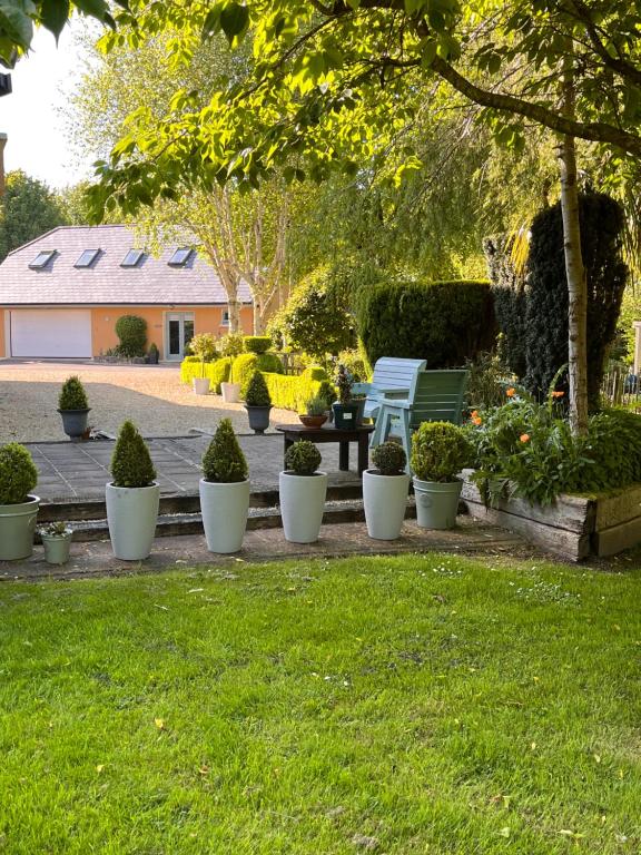 a park with a bench and potted plants at The Mews in Newbridge