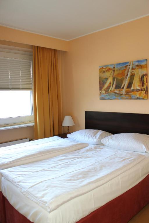 Postel nebo postele na pokoji v ubytování Wiking Hotel