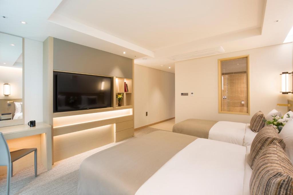 Postel nebo postele na pokoji v ubytování Hotel Central Bay