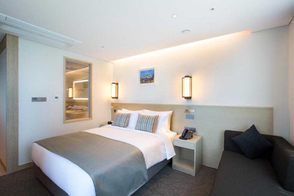 Postel nebo postele na pokoji v ubytování Hotel Central Bay