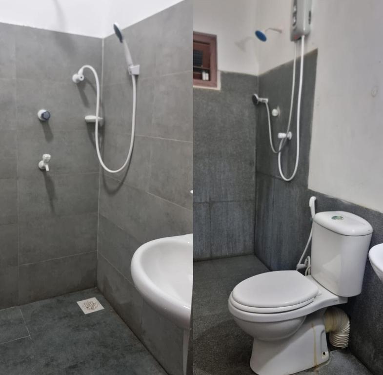 a bathroom with a toilet and a sink and a shower at Holiday Bungalow for rent, Inuvil, Jaffna in Uduvil