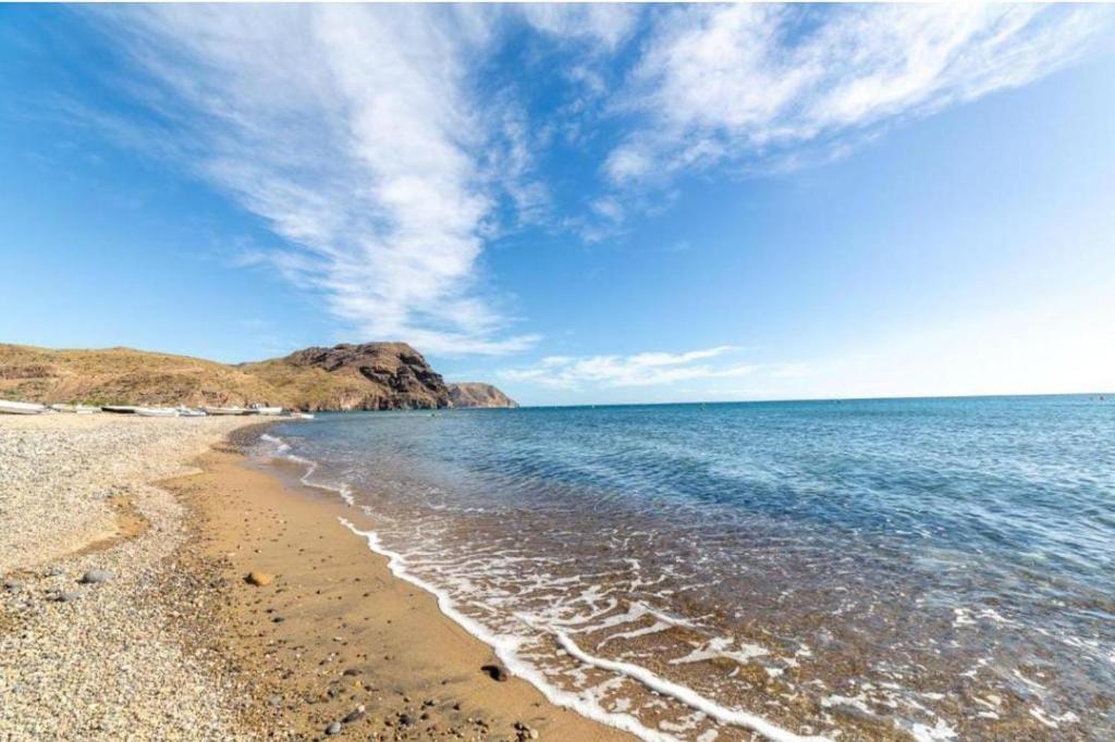 a beach with a blue sky and the ocean at Estación Las Negras in Las Negras