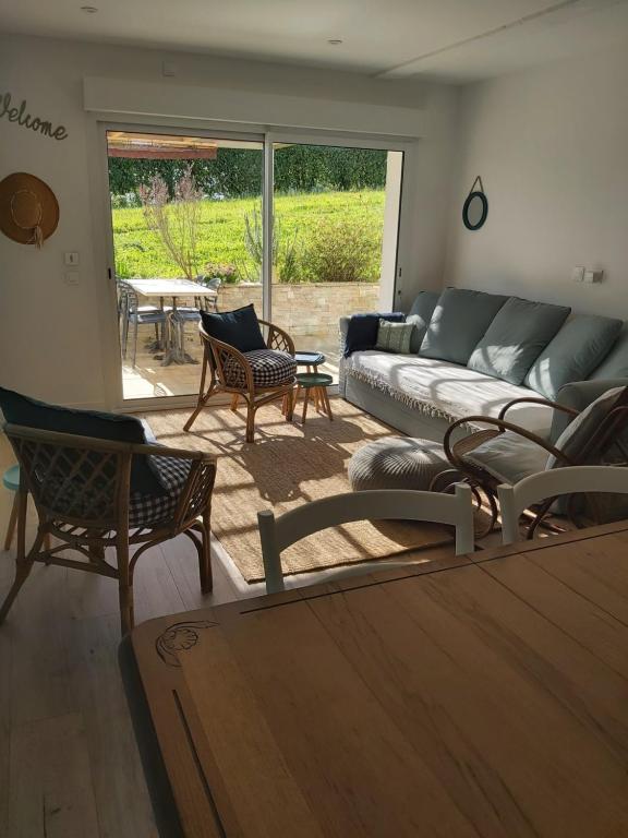 a living room with a couch and chairs and a table at Saint jean de luz acotz in Saint-Jean-de-Luz
