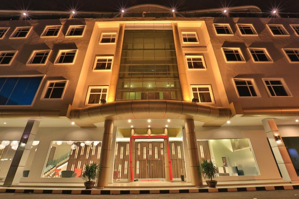 a large building with a red door in front of it at Supreme Hotel in Melaka