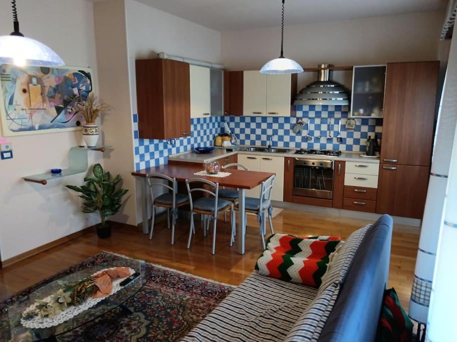 a living room with a couch and a table in a kitchen at Ornella's apartment in Casale di Scodosia