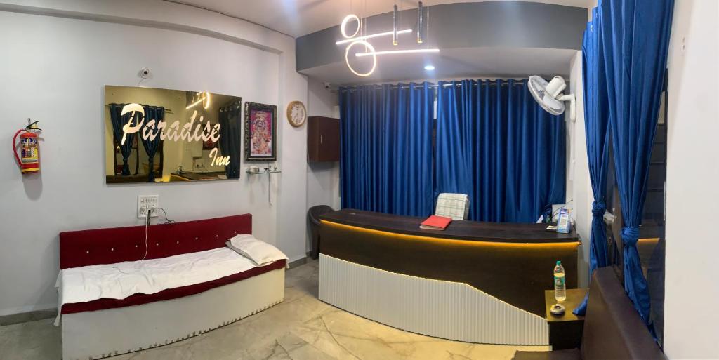 ein Zimmer mit einem Salon mit einem Sofa und einem Tisch in der Unterkunft Hotel Paradise Inn in Indore