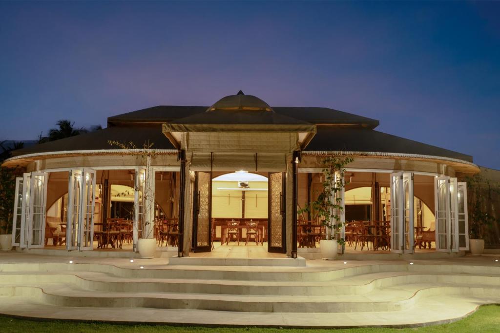 a large building with a staircase in front of it at Bali Beach Glamping in Tabanan