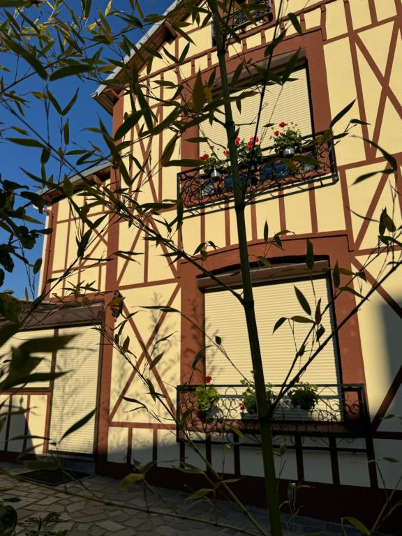 a building with flower boxes and a window at Maison Colombage normande in Flers