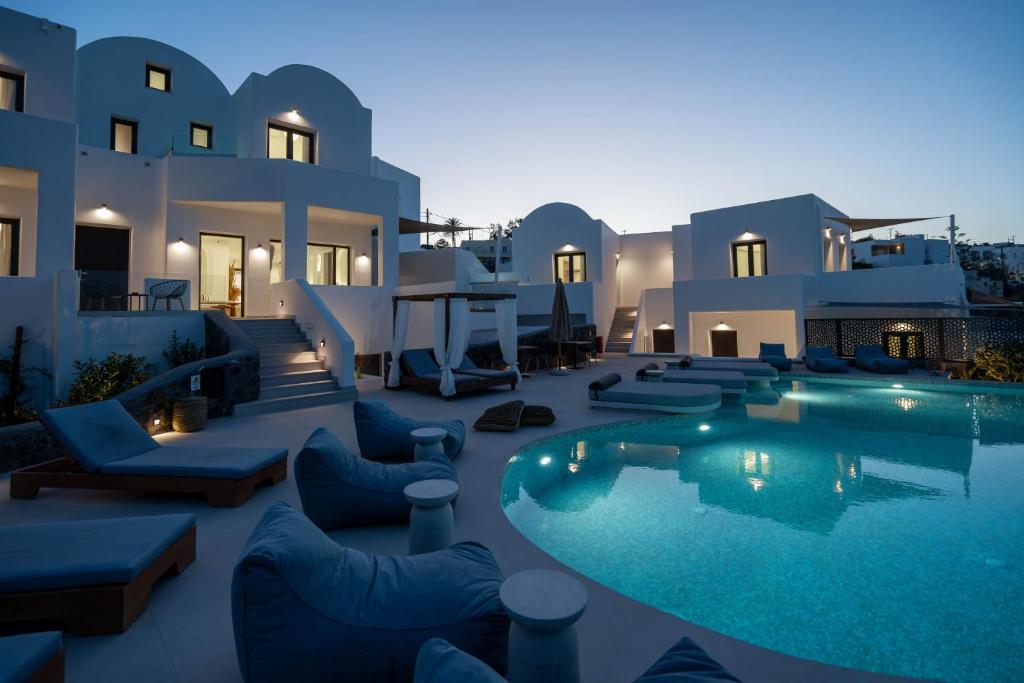 uma villa com piscina à noite em CUORE SANTO SUITES em Fira