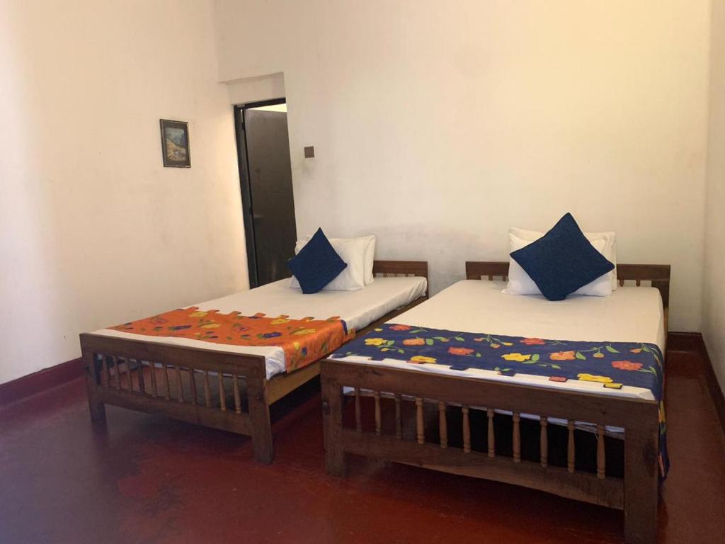 Postel nebo postele na pokoji v ubytování Kandy Siebel Bungalow