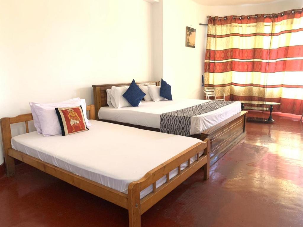 Postel nebo postele na pokoji v ubytování Kandy Siebel Bungalow