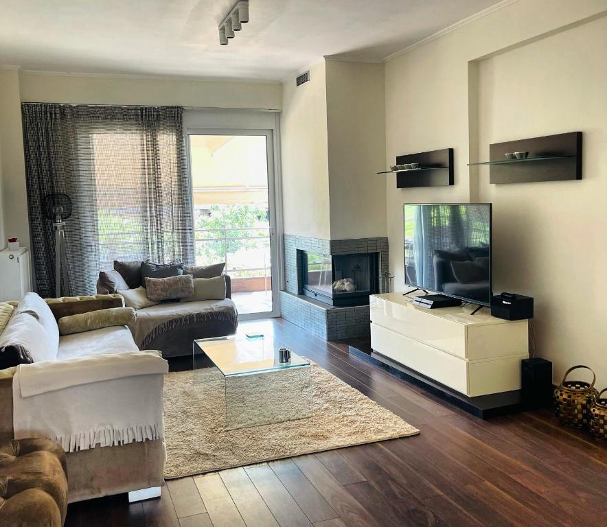 a living room with a couch and a television at Sea view villa in Preveza