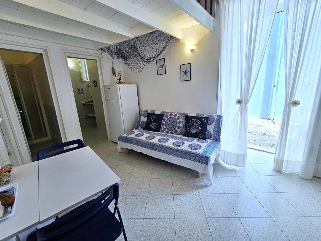 a living room with a couch and a refrigerator at Maridea - O'Sarracino in Ponza