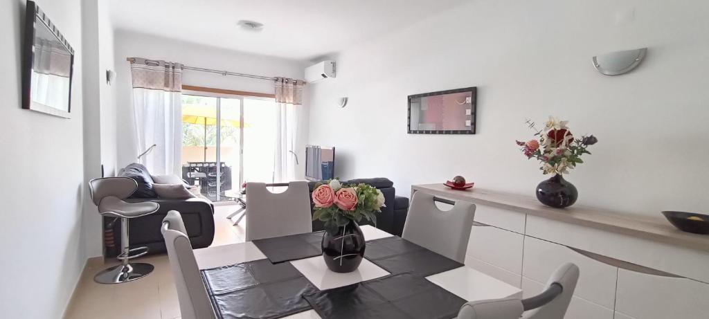 a living room with a table and chairs at Royal Cabanas Golf by Amandio Batista in Cabanas de Tavira