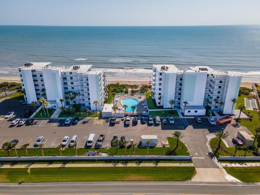 an aerial view of the beach and buildings at Shorehom by the Sea 51 in New Smyrna Beach
