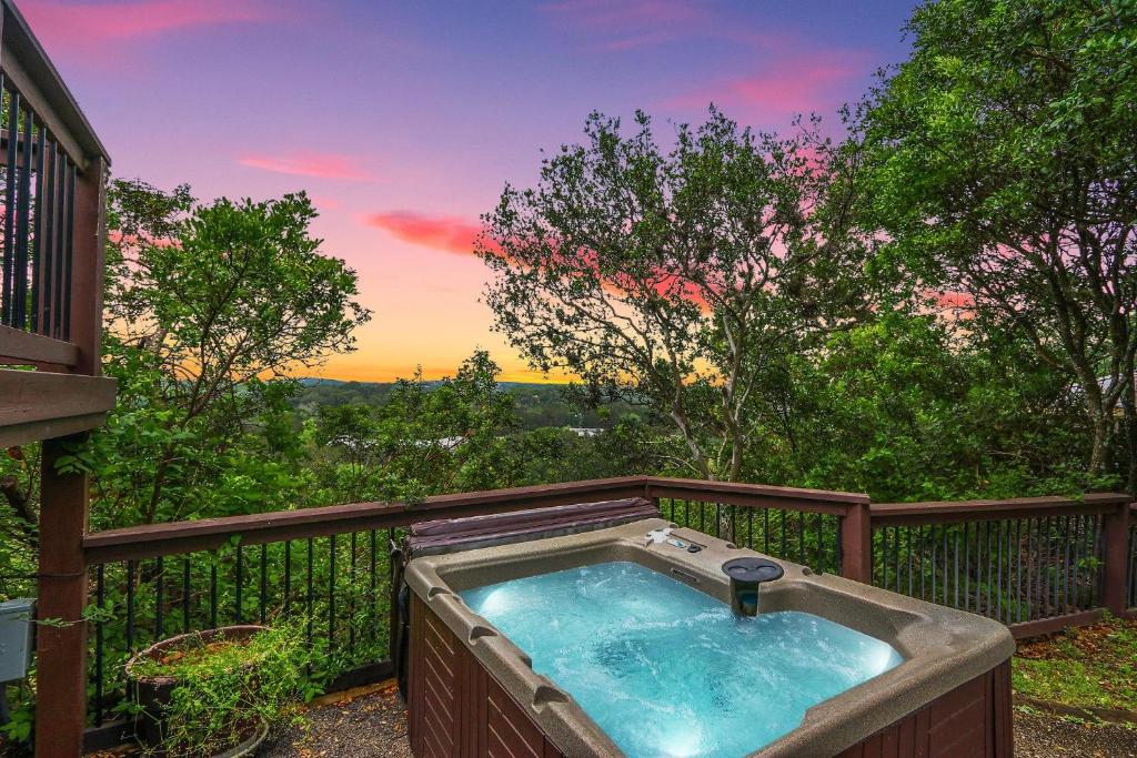 a hot tub on the deck of a house at Clutter Falls Retreat- Main House in New Braunfels