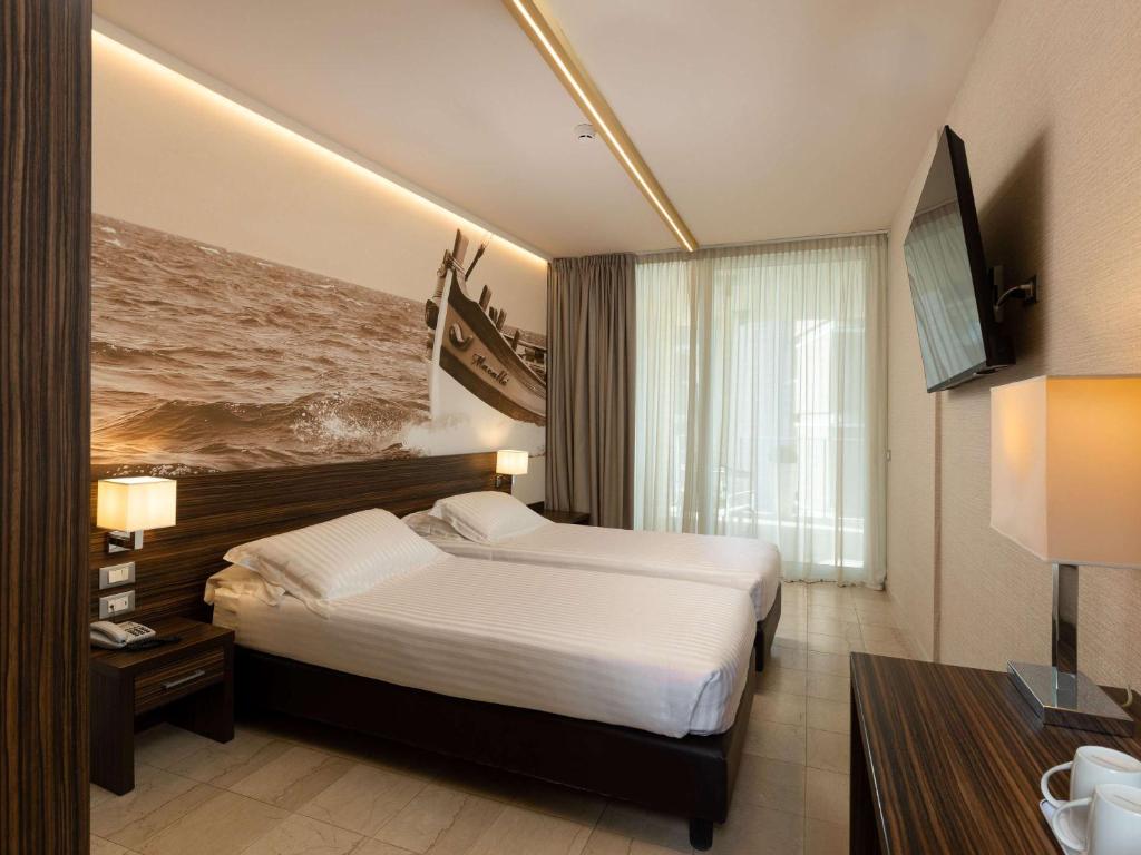 Posteľ alebo postele v izbe v ubytovaní Mercure Rimini Lungomare