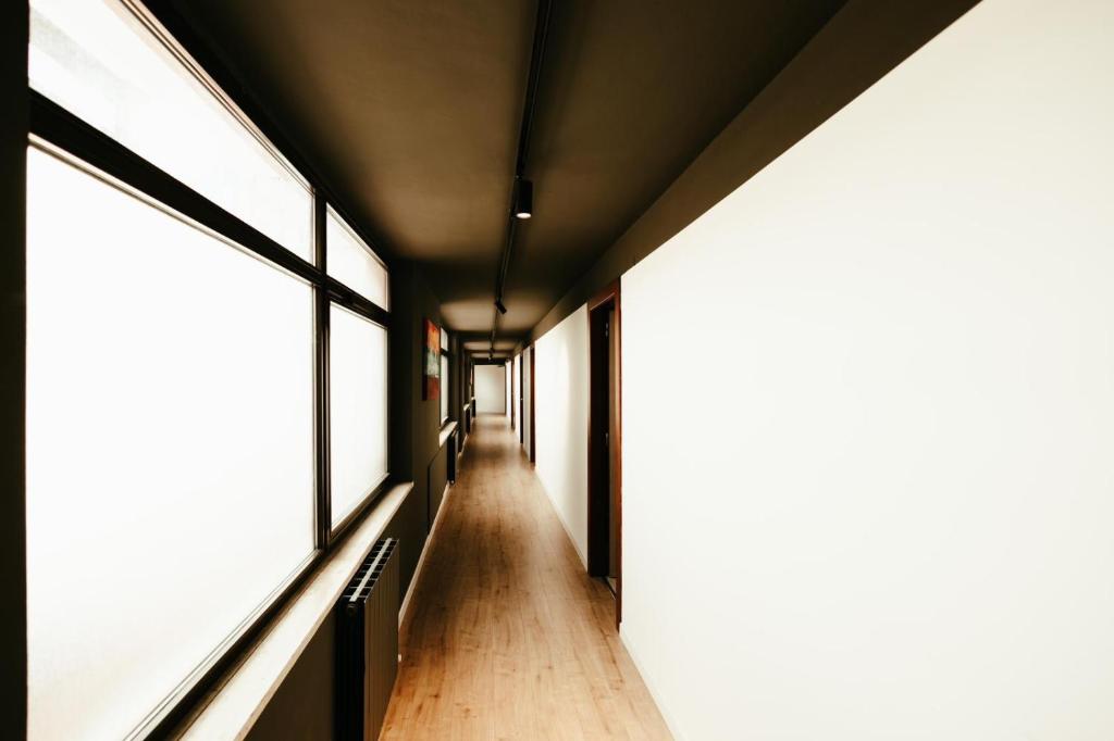 a hallway of a building with windows at HOTEL BRUNFORTE in Sarnano