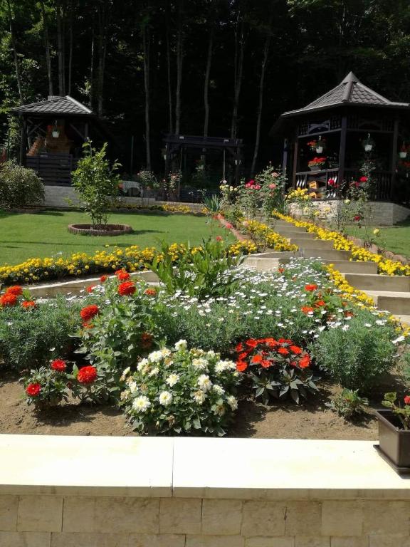 a garden of flowers in front of a gazebo at Casa Hera in Sinaia