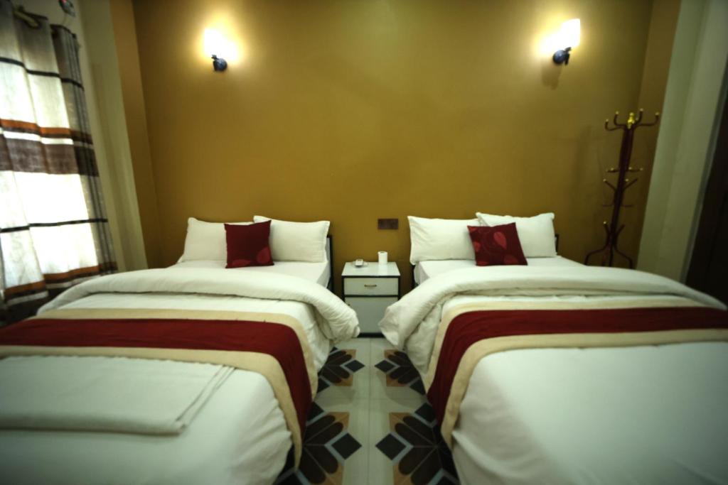 Letto o letti in una camera di Hotel Flycatcher Chitwan- A jungle Safari Home