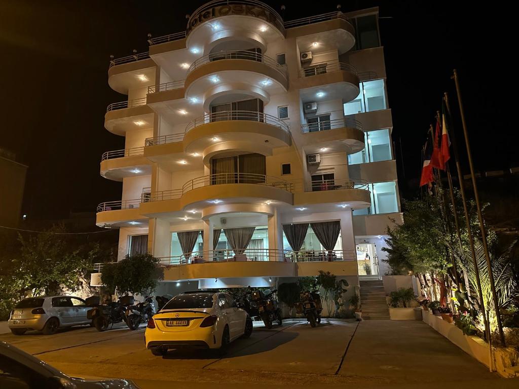 a yellow car parked in front of a building at Oskar Hotel in Sarandë