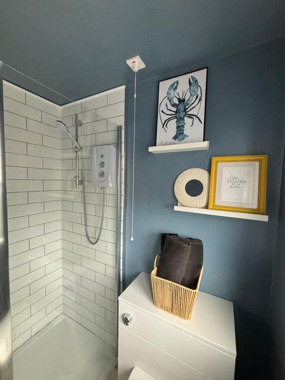 a bathroom with a shower and a toilet and a sink at Lovely spacious loft close to train station in Worthing