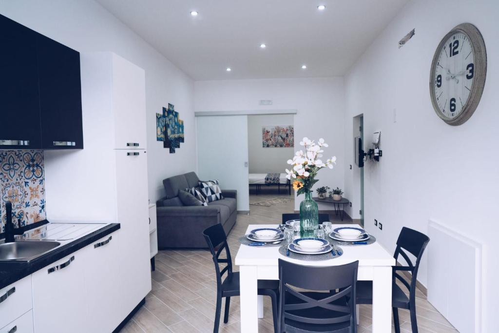 a kitchen and living room with a table and chairs at Scorcio di Mare By Dimora Hub in Balestrate