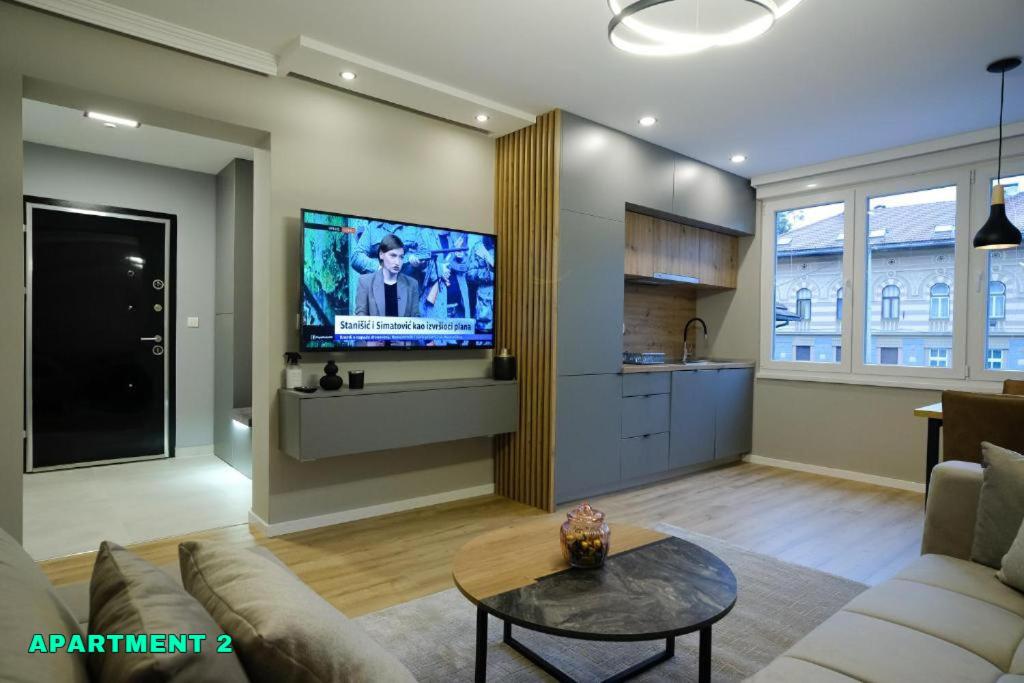 a living room with a couch and a tv at Residence 14 Sarajevo in Sarajevo