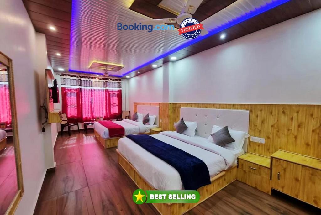 a bedroom with two beds in a room at Goroomgo Grand Kailash View Home Stay Himachal pradesh in Khajjiar 