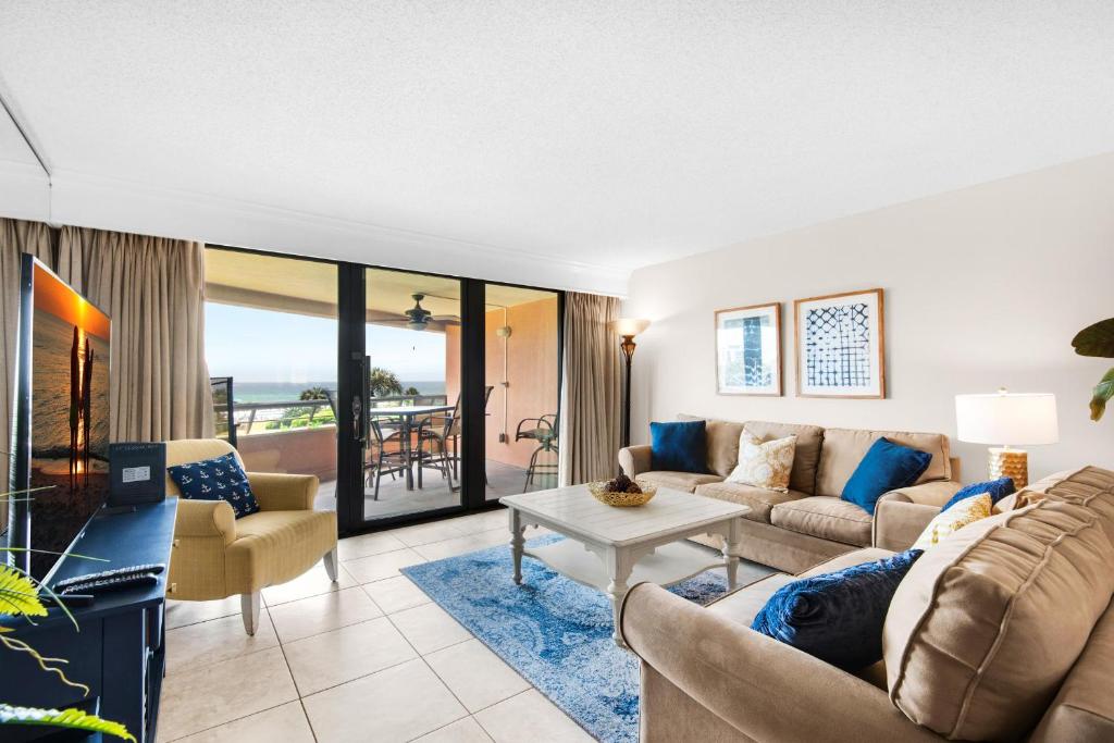 a living room with a couch and a table at Edgewater #303 in Destin