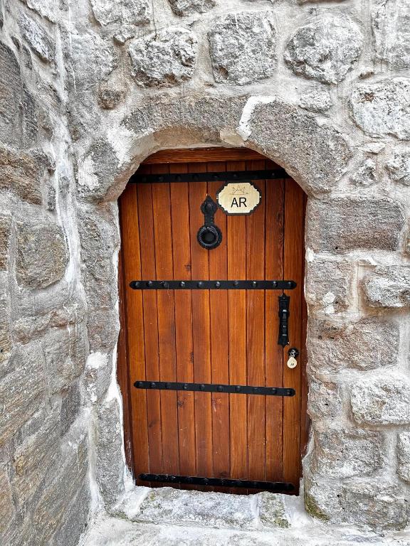 a wooden door in a stone wall at AREV OTEL in Mardin