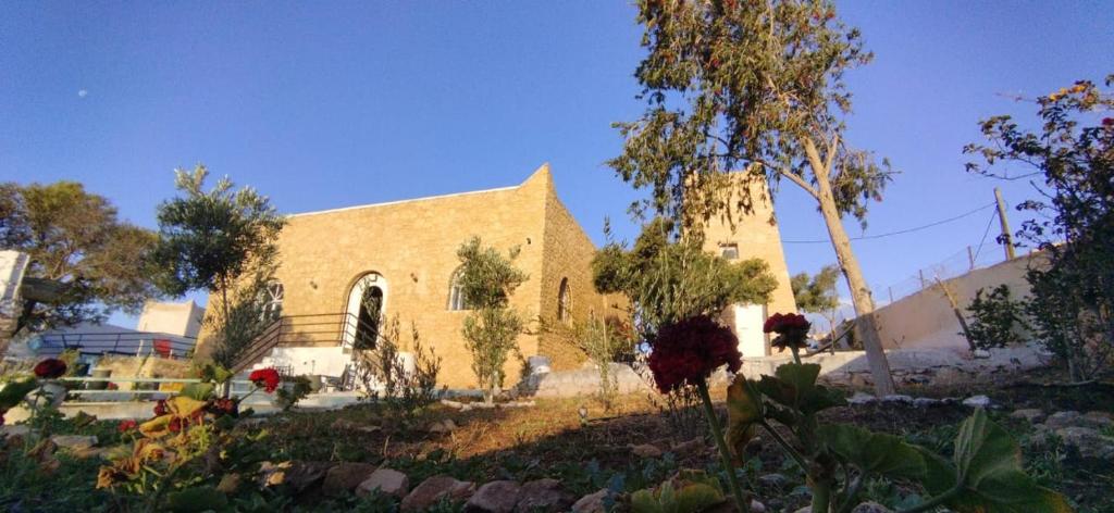 a church with a building in the middle of a garden at Villa chez NADA in Essaouira