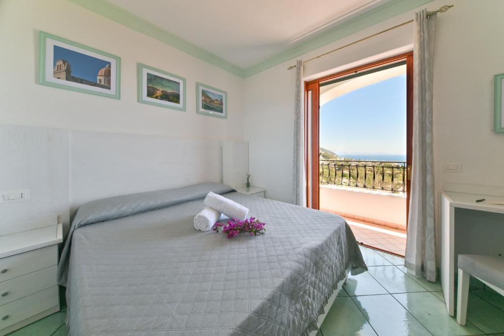 a bedroom with a bed and a large window at Villa Eleonora, un angolo di Paradiso ad Ischia in Ischia