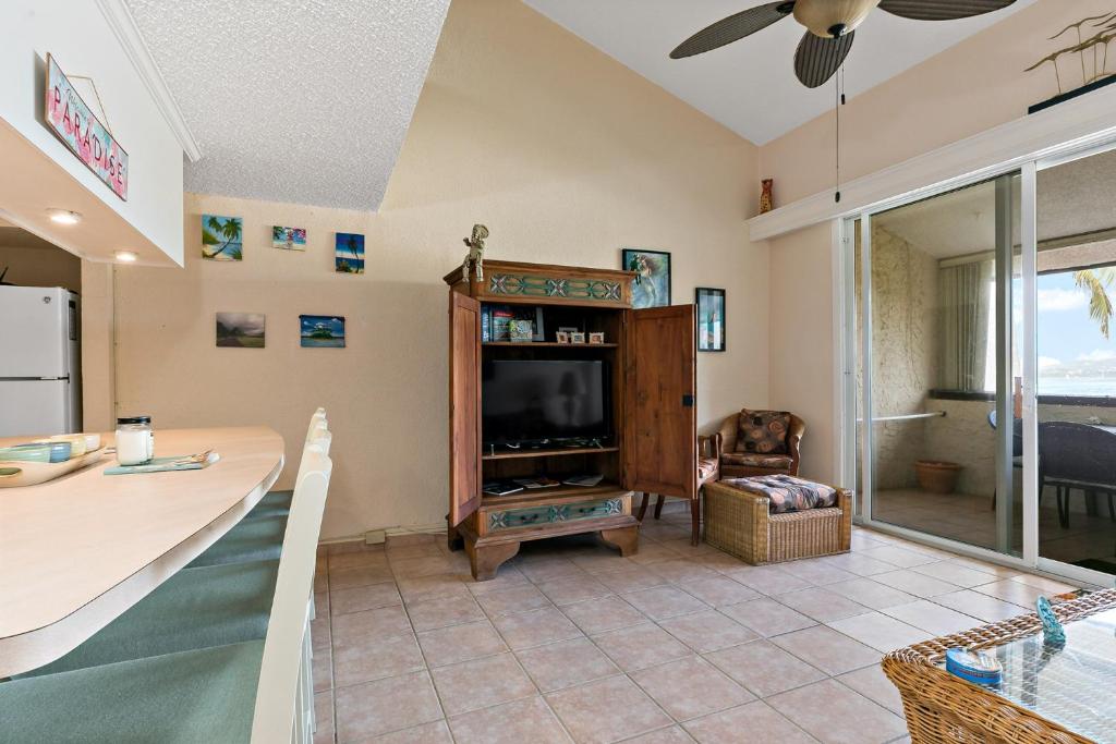 a living room with a television and a table at Another Beautiful Day In Paradise in Christiansted