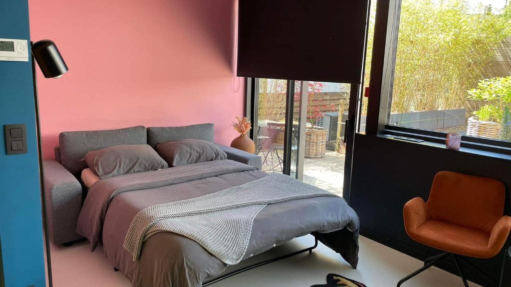 a bedroom with a bed and a large window at NEOZONE Neostudio Malmedy in Malmedy