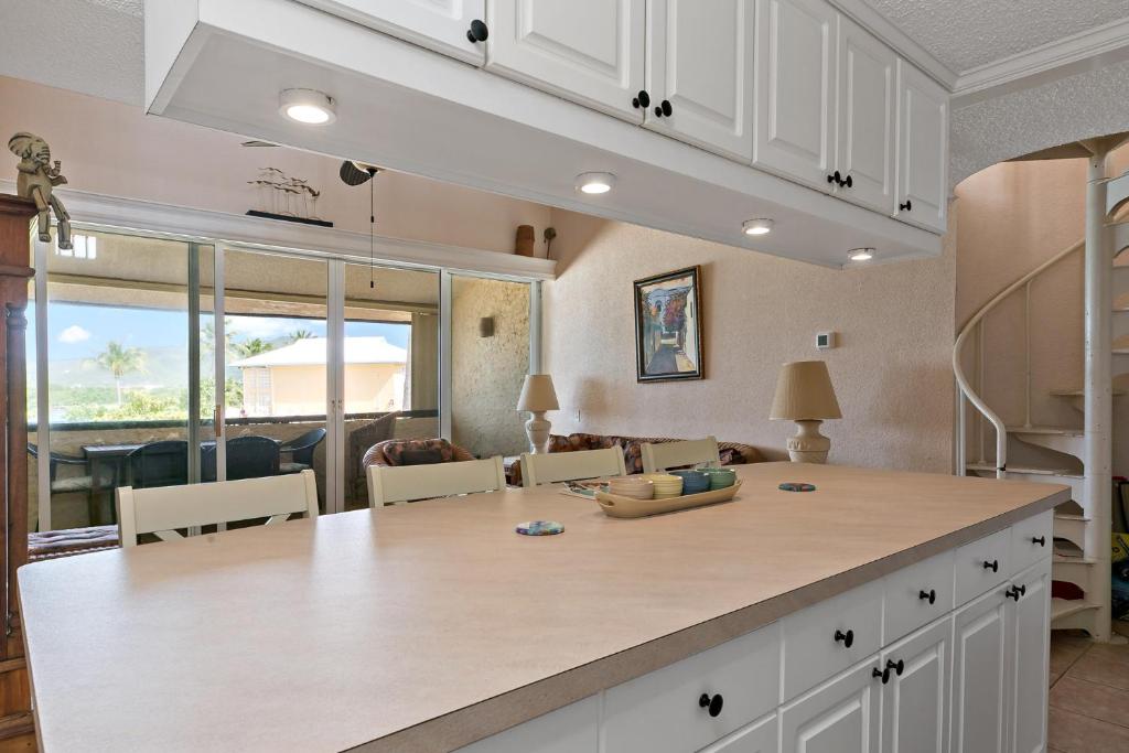 a kitchen with a large island and a living room at Another Beautiful Day In Paradise in Christiansted
