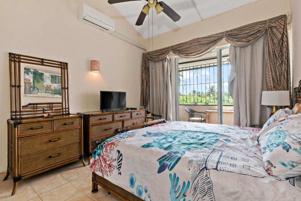 a bedroom with a bed and a dresser and a mirror at Another Beautiful Day In Paradise in Christiansted