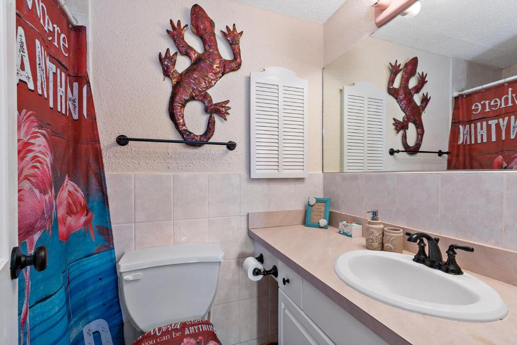 a bathroom with a toilet and a sink at Another Beautiful Day In Paradise in Christiansted