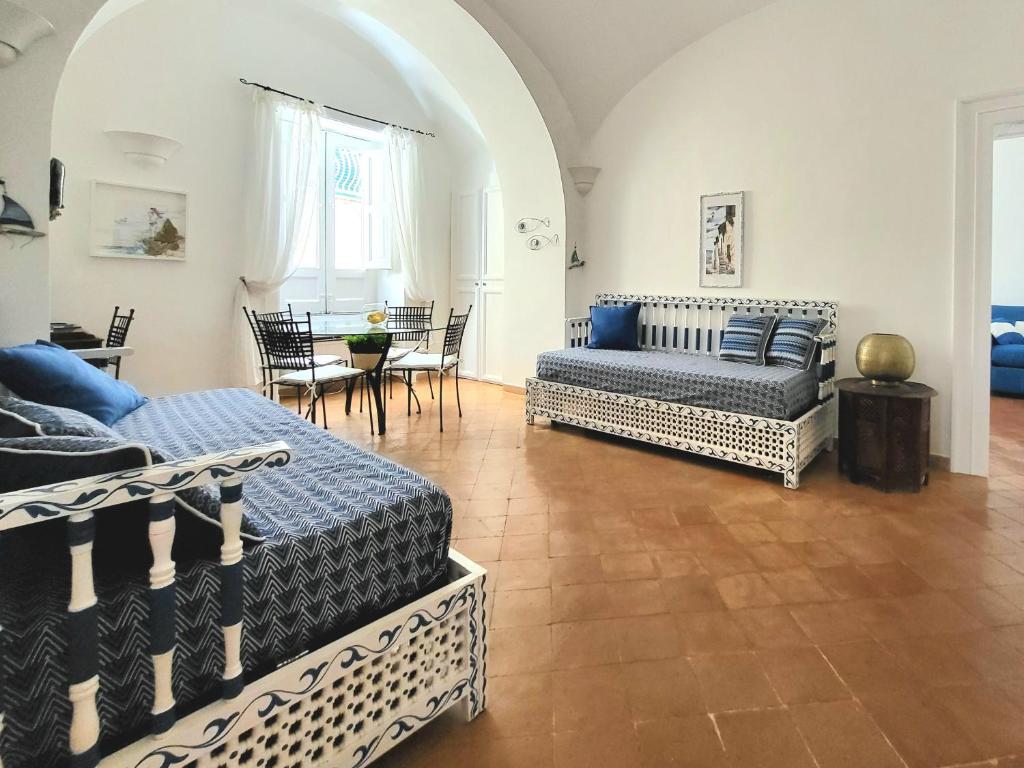 - un salon avec deux lits et une table dans l'établissement Vicolo 23 House, à Atrani
